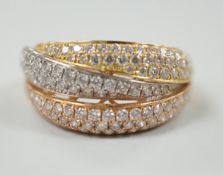 A modern three colour 18ct gold and diamond chip cluster set three row crossover ring, size O, gross