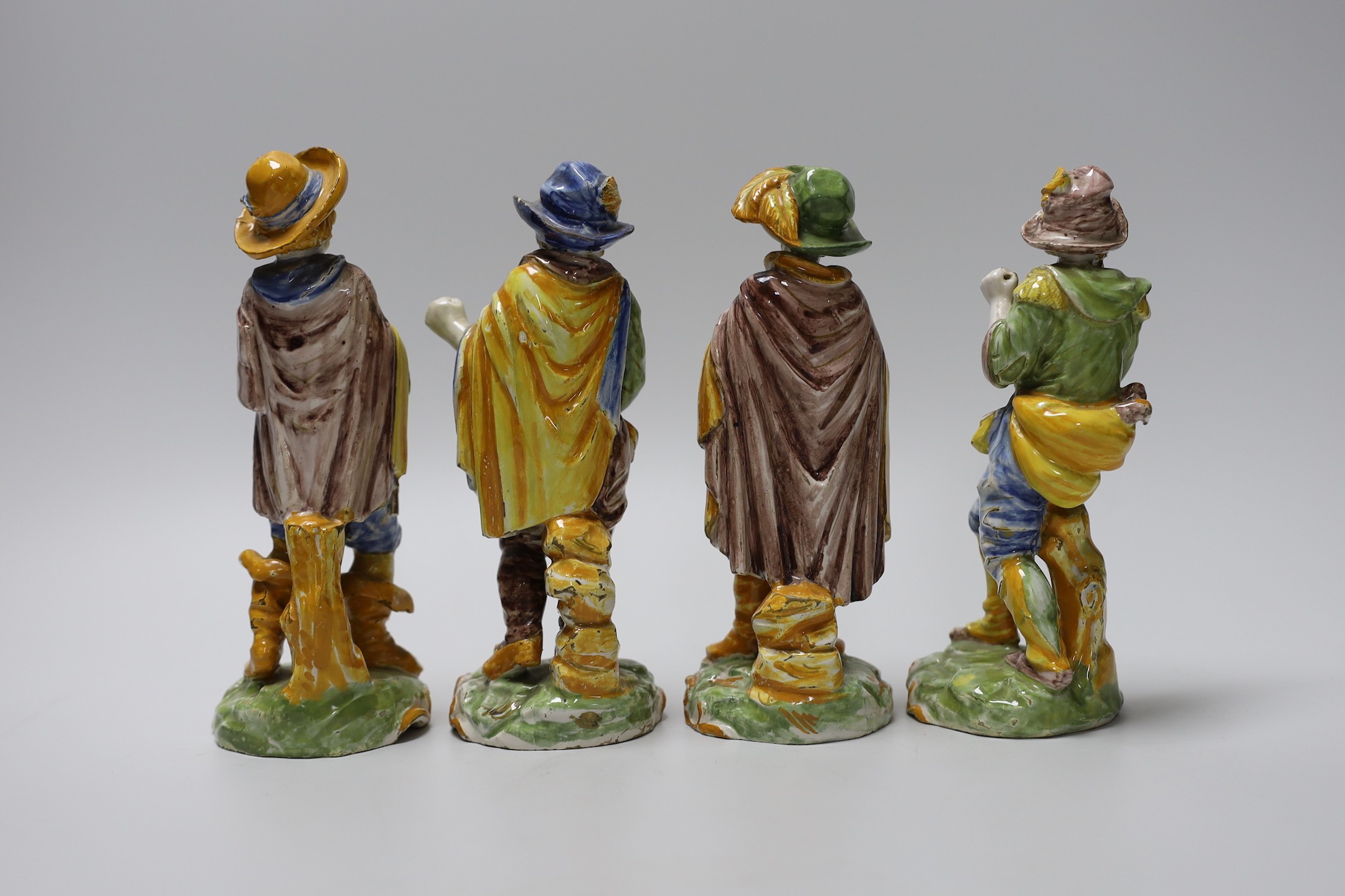A set of four 19th century faience figures of street peddlers or performers - 18cm tall - Image 2 of 3