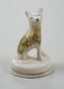 A seated toy Staffordshire model of a cat with tortoiseshell markings, c.1830-50. 4.5cm