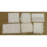 A quantity of lace trimmed and embroidered fabrics including tray cloths and pillow cases