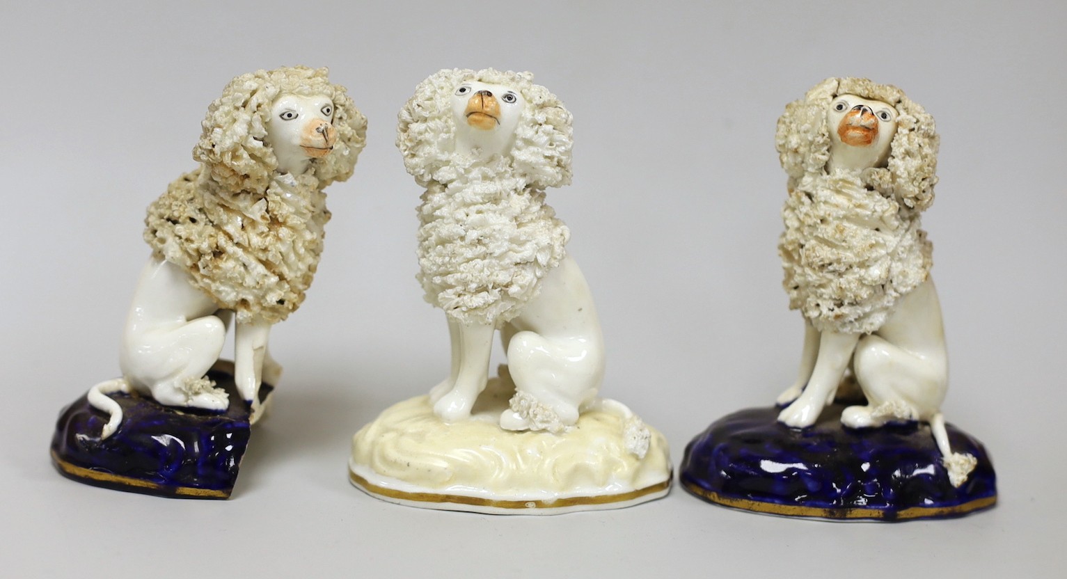 Three small Samuel Alcock models of seated poodles, c.1830-50. Tallest 9cms highProvenance: Dennis