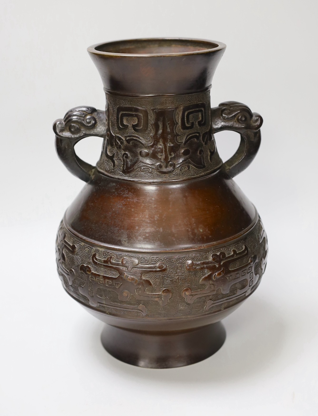 A Chinese archaistic bronze double handled 'hu' vase, 19th century, 27.5cm high