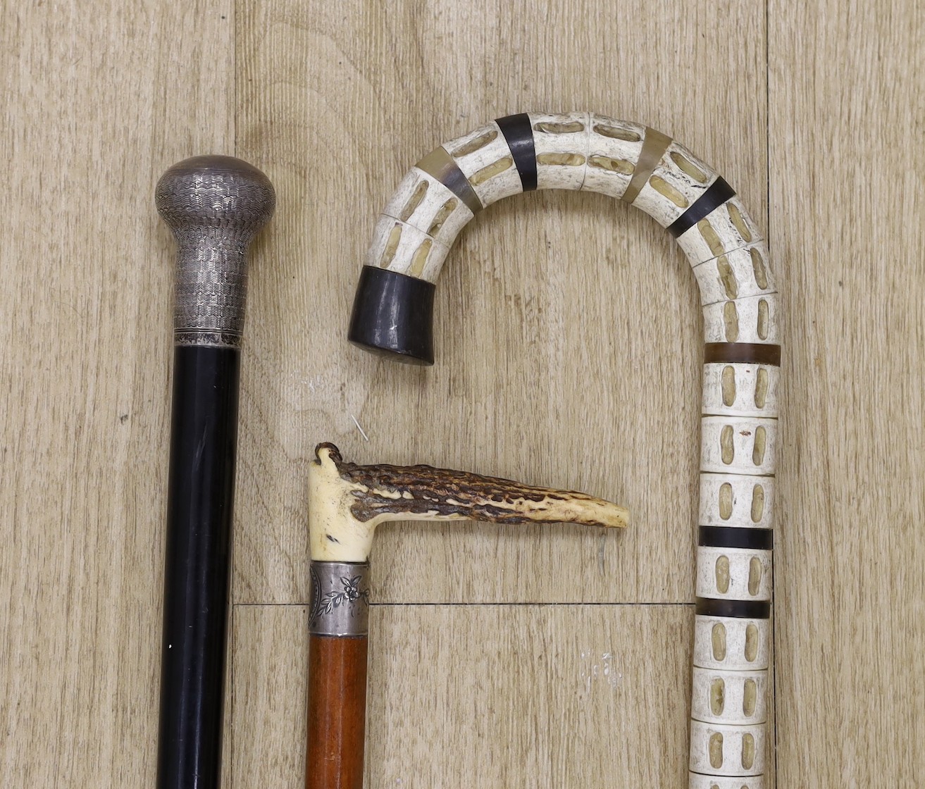 A silver mounted ebony walking cane, a shark vertebrae walking stick and a stag antler mounted - Image 2 of 2