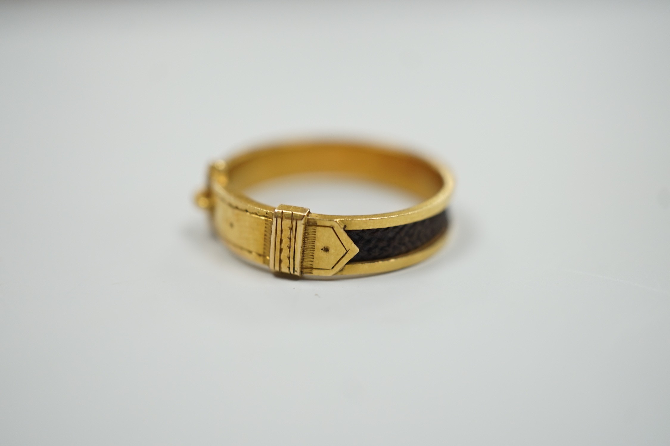 A 19th century yellow metal and plaited hair mourning band, modelled as a buckle, the shank interior - Image 2 of 6