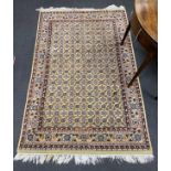 A North West Persian ivory ground rug, 190 x 124cm