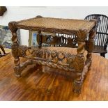 A Jacobean revival carved oak cane seat stool width 52cm, depth 39cm, height 43cm.