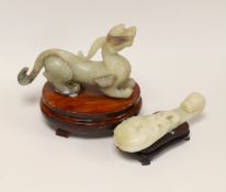 A Chinese pale celadon and grey jade mythical beast on stand and a pale celadon jade belt hook,
