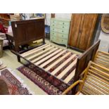 An 18th century style panelled oak bedframe, length 198cm, width 122cm, height 130cm