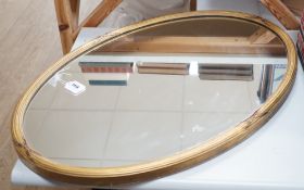 A Victorian oval giltwood framed mirror, 86x58cm