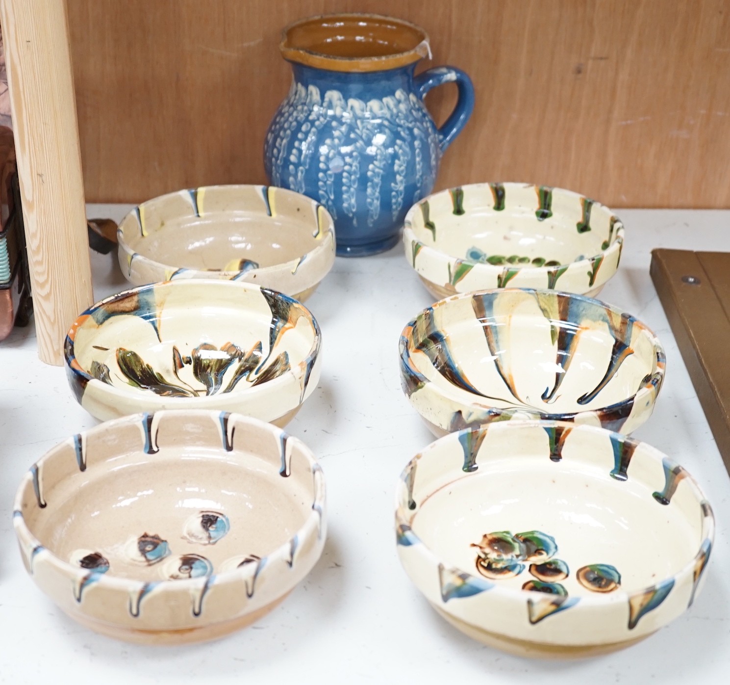 A set of six French provincial pottery bowls and a similar jug