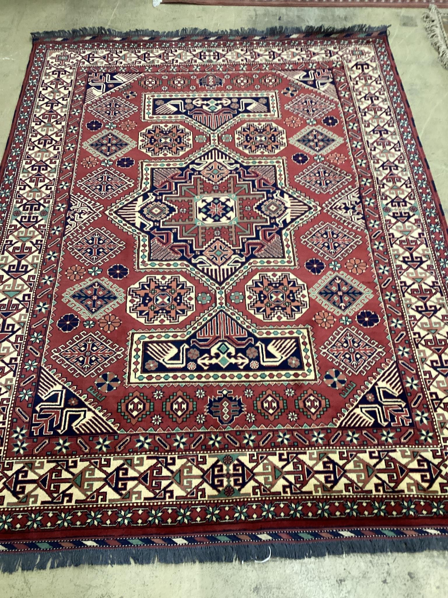 A modern Caucasian style red ground carpet 300cm x 210cm