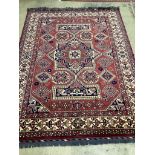 A modern Caucasian style red ground carpet 300cm x 210cm