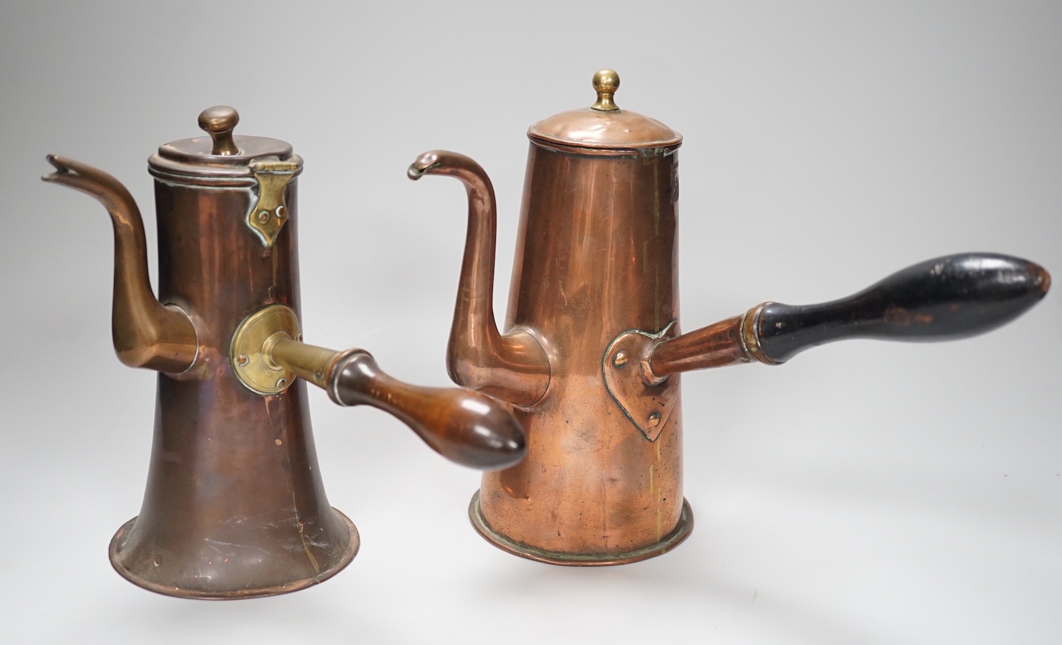 Two 18th century copper tavern coffee pots. Tallest 22.5cm