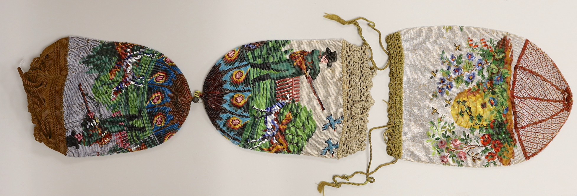 Two 19th century draw string beaded bags with hunting scenes, possibly American and a similar beaded