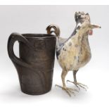 An 18th century Scandinavian carved wood tankard and a 19th century painted tin plated iron model of