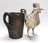 An 18th century Scandinavian carved wood tankard and a 19th century painted tin plated iron model of