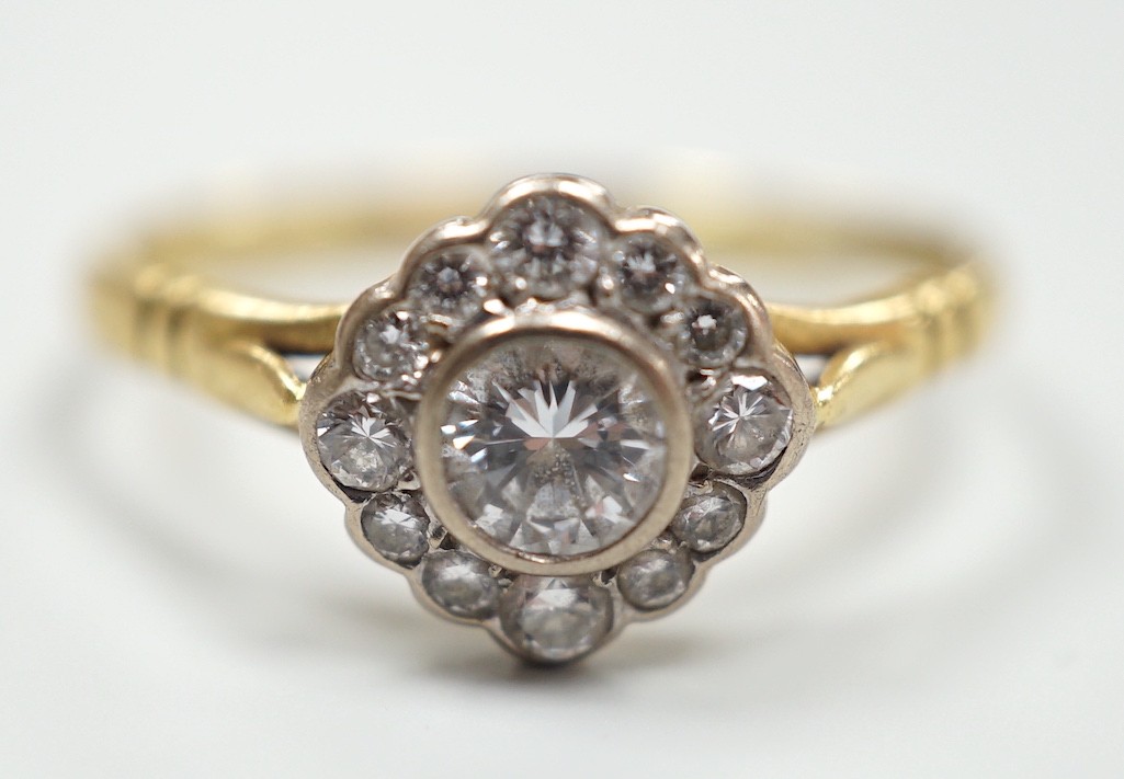 A modern 18ct gold and single stone diamond ring, with diamond set border, size S, gross weight 3.