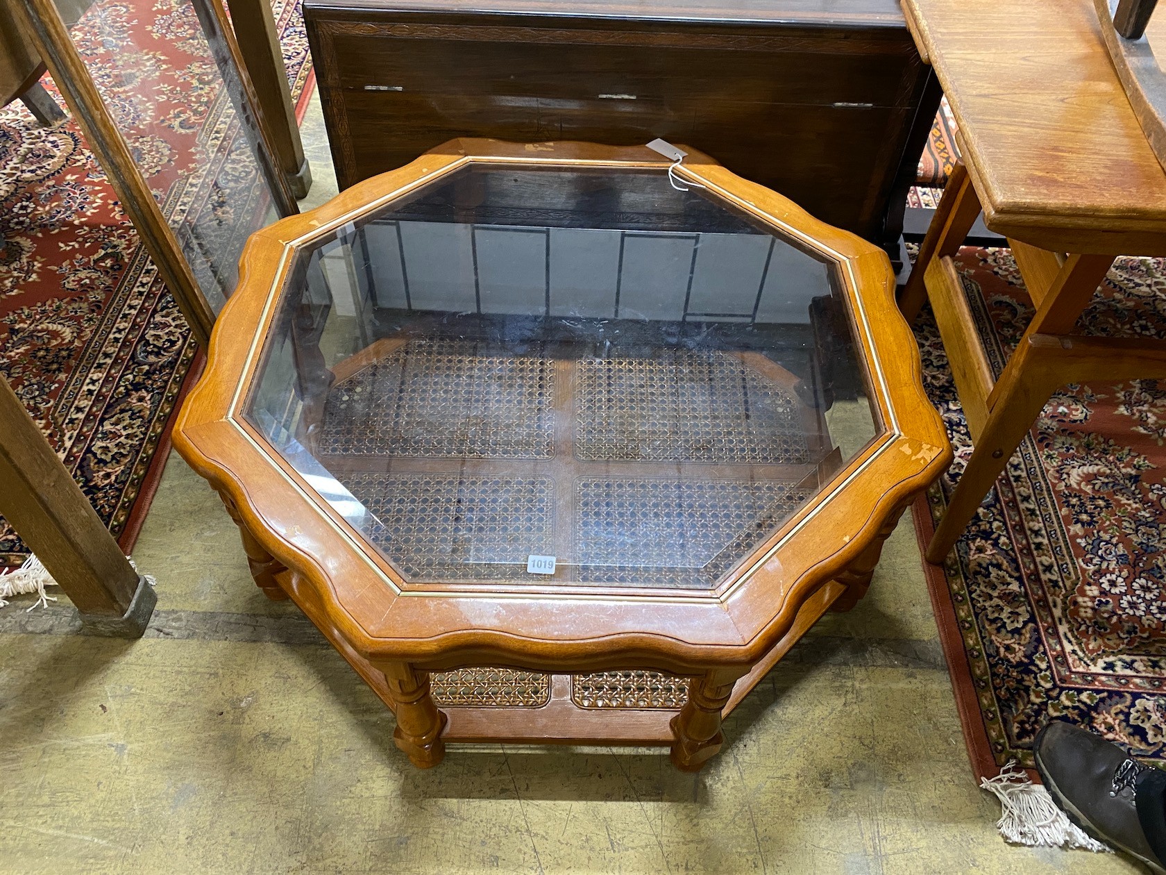 A modern octagonal brass mounted walnut glass top coffee table with caned undertier, diameter 100cm, - Image 2 of 2