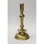 A 17th century continental brass candlestick. 28cm high