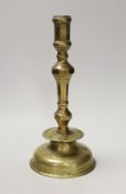 A 17th century continental brass candlestick. 28cm high