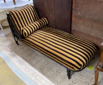 An Aesthetic period ebonised chaise longue, in the manner of E. W. Godwin, length 164cms, depth