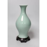 A Chinese celadon glazed vase, hallmark to base, wood stand. 24.5cm high