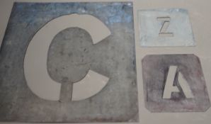 A complete set of zinc alphabet stencils, two incomplete sets of alphabetic stencils and one