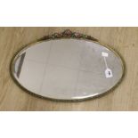 An oval painted floral barbola wall mirror, 71cms wide