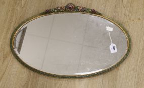 An oval painted floral barbola wall mirror, 71cms wide