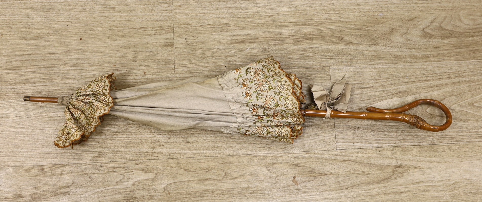 An embroidered parasol with bamboo handle. 88.5cm high