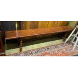 An 18th century style Italian design hardwood bench with wrought iron stretcher, length 213cm, depth