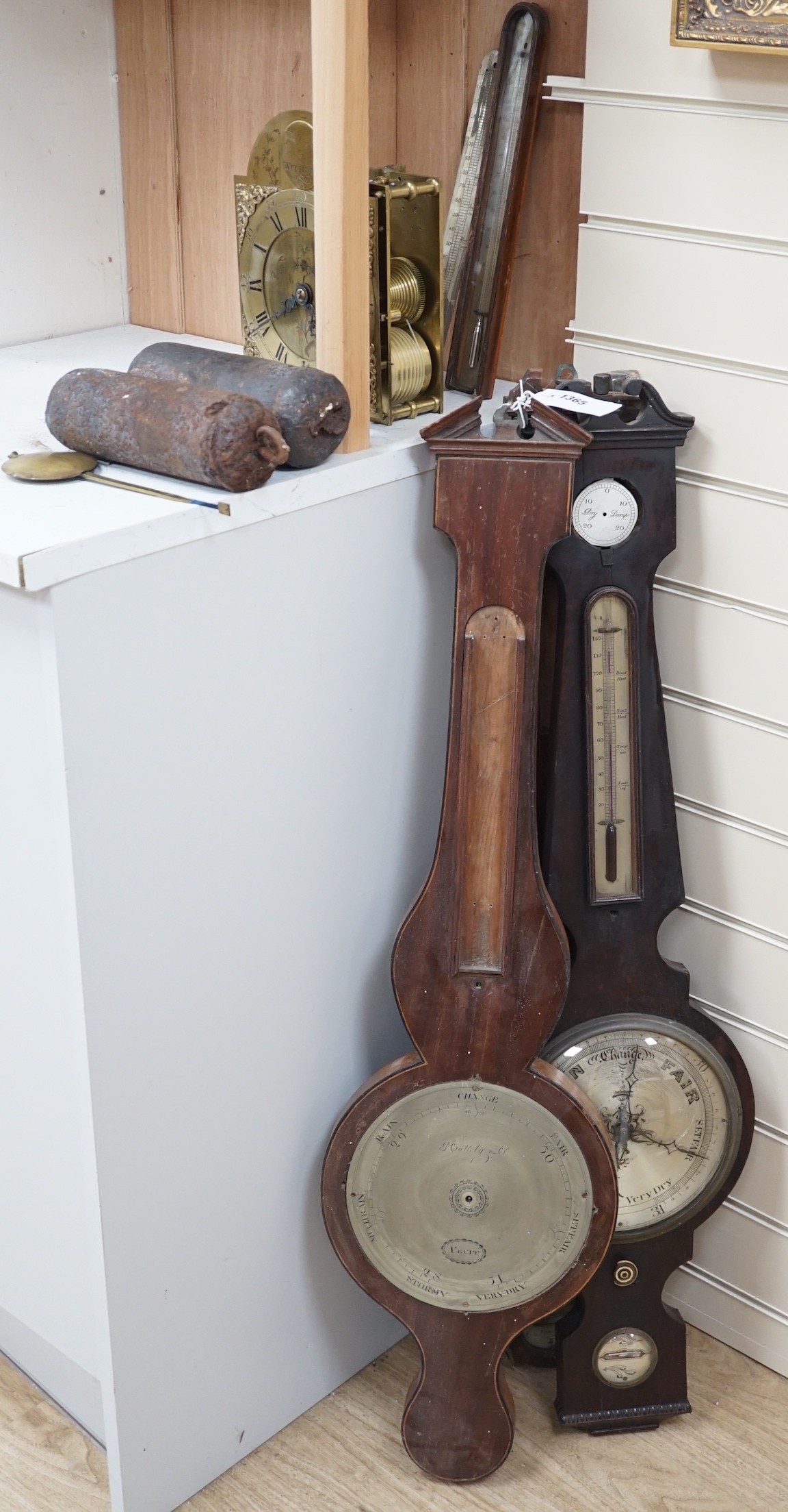 A 19th century bracket timepiece movement, a pair of iron clock weights and three barometer