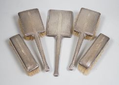 A 1930's Art Deco silver silver mounted five piece brush and mirror set, Birmingham, 1937.