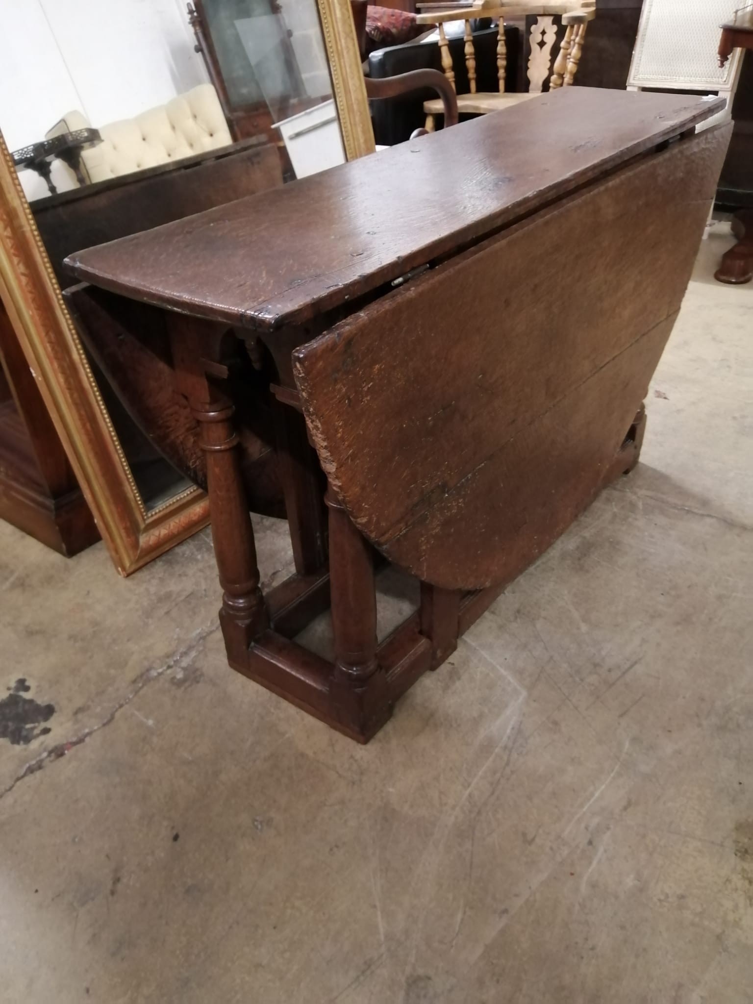 A 17th century oak gateleg table, (incorporates new timber to foot) length 152cm extended, width