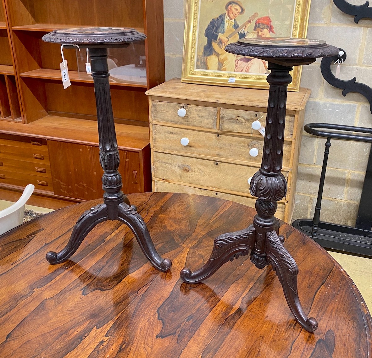 A near pair of Victorian style tripod tables with circular specimen marble tops, larger diameter