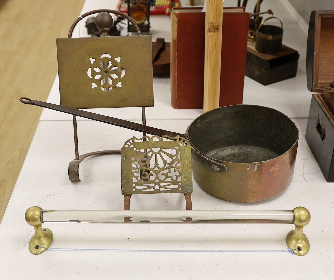 Two brass grate trivets, a crystal and brass towel rail and a 19th century copper pot