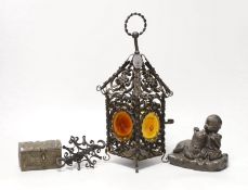 A wrought iron lantern, similar pendant hook, cast miniature brass trunk and bronze effect group,