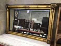 A William IV giltwood and composition overmantel mirror with ebonized slip width 106cms, height