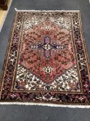 An Heriz red ground rug, 200cms x 148cms