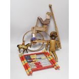 A Victorian carved pine jointed peg doll, jointed wood uni-cyclist toy, two abacuses and an early