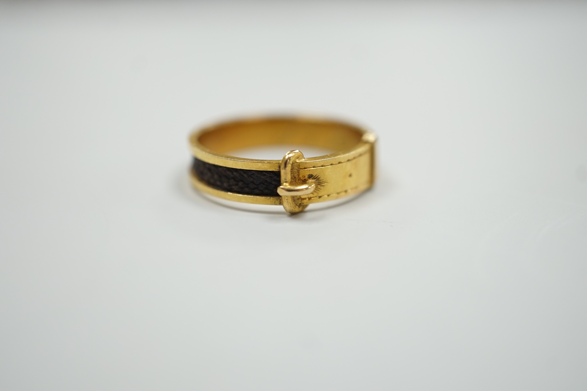 A 19th century yellow metal and plaited hair mourning band, modelled as a buckle, the shank interior - Image 4 of 6