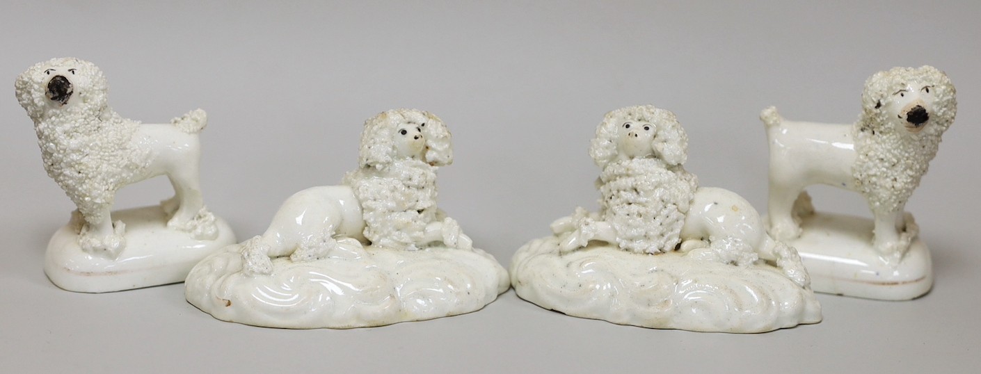 Two pairs of small Staffordshire models of poodles; one pair recumbent and the other standing, c.