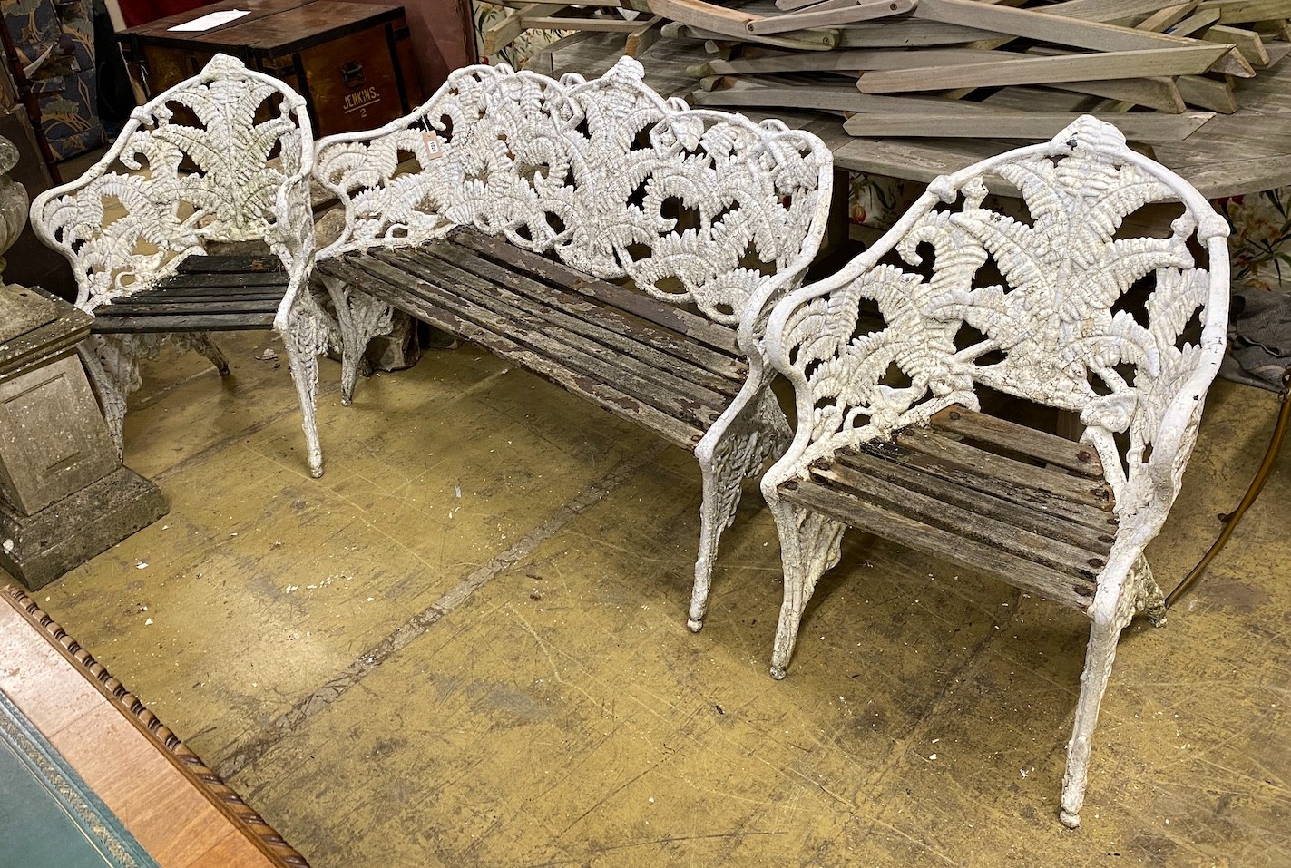 A Victorian style fern pattern painted cast metal garden bench and two chairs, length 151cm, depth