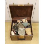 A suitcase containing a collection of late 19th century leather sewing bags and containers, wooden