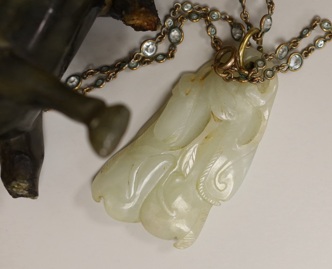 A 19th century Chinese pale celadon jade pendant a Chinese blanc de Chine figure, two soapstone - Image 3 of 5