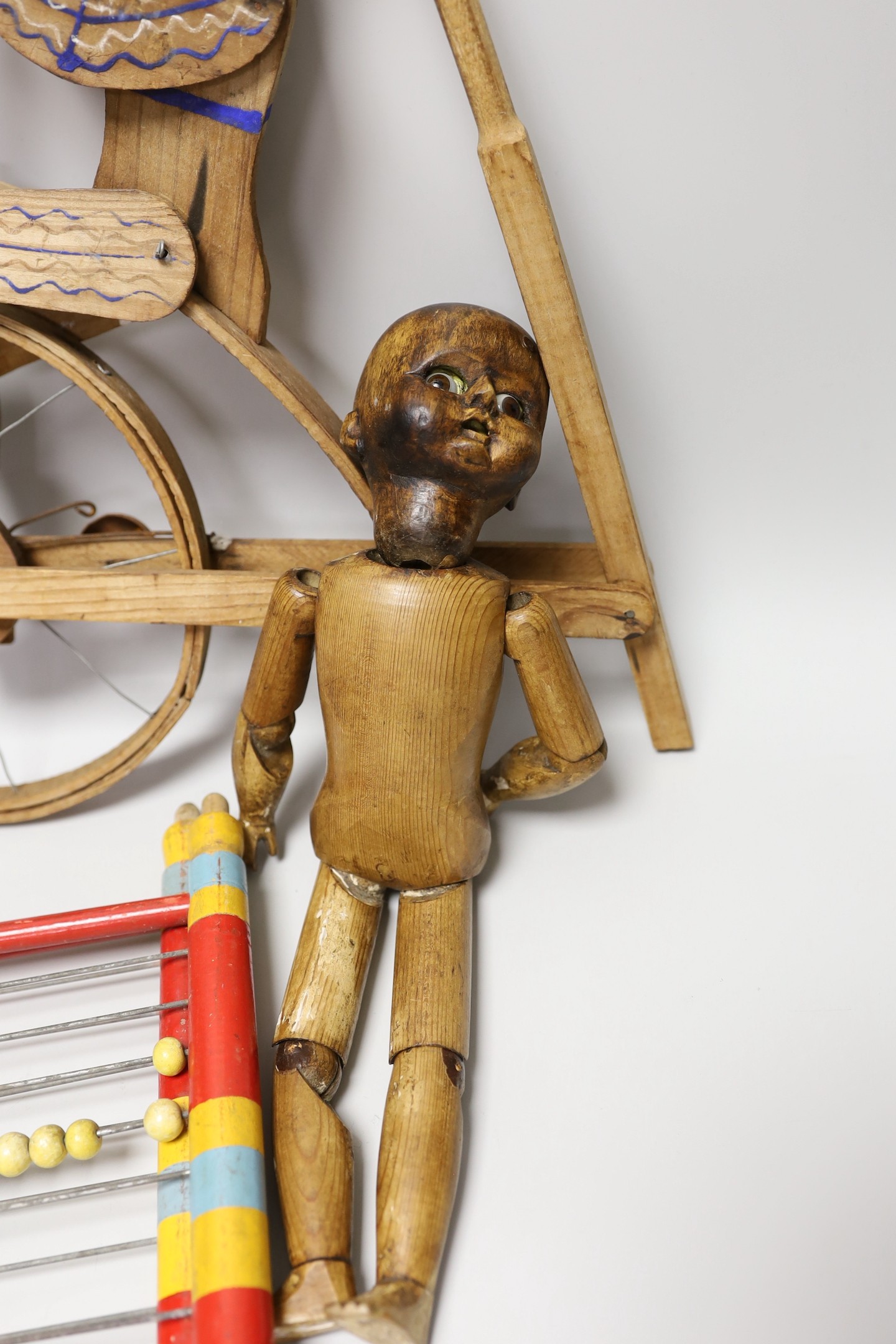 A Victorian carved pine jointed peg doll, jointed wood uni-cyclist toy, two abacuses and an early - Image 3 of 5