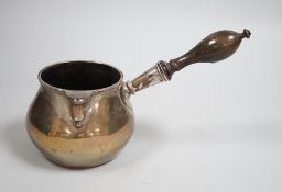 A late 18th/early 19th century white metal brandy warmer, with turned wooden handle and spout with