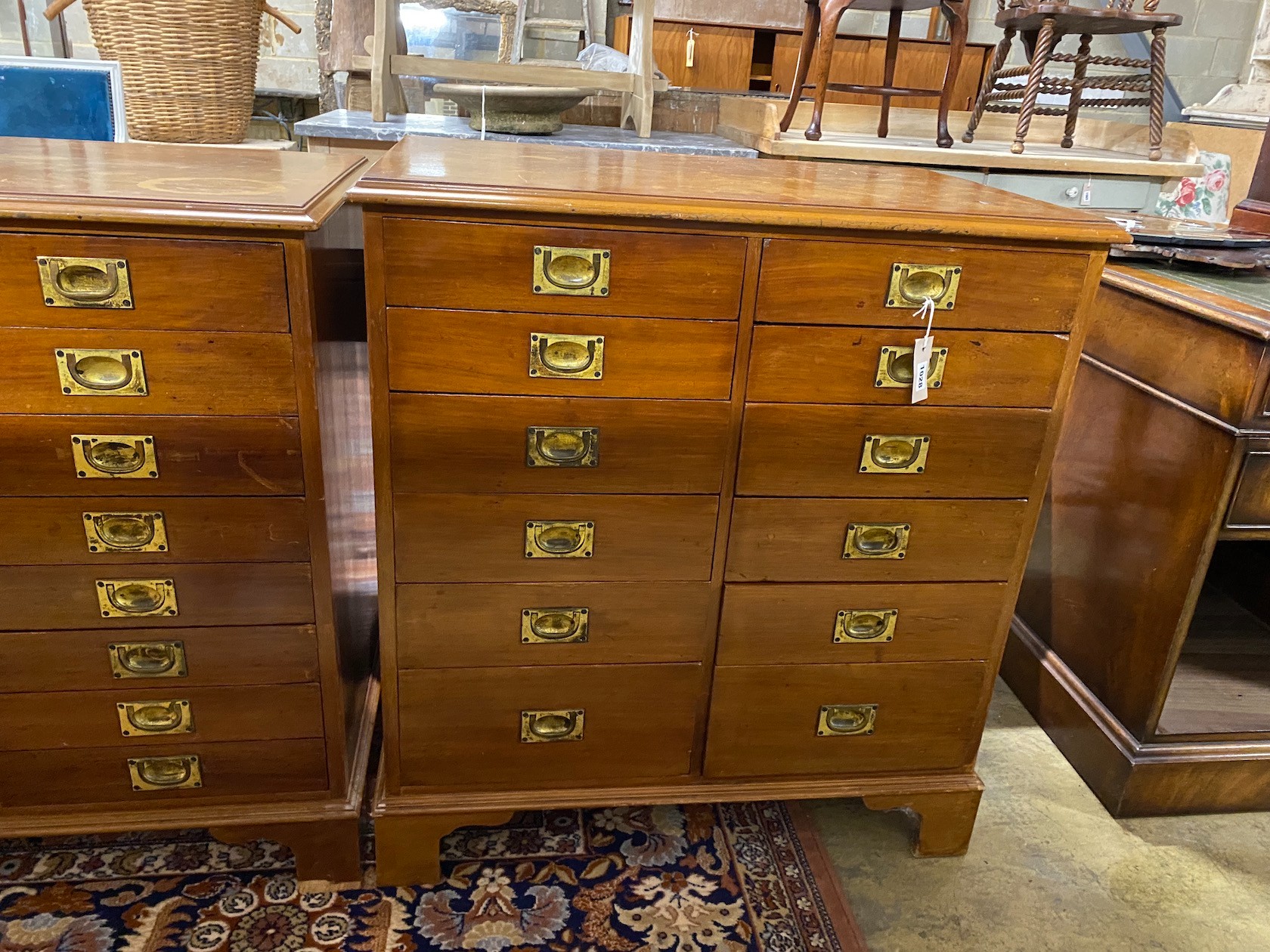 A near pair of mahogany and walnut military style chests of drawers, larger width 82cm, depth - Image 2 of 3