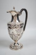 A late Victorian repousse silver pedestal hot water jug, Charles Stuart Harris, London, 1893, height