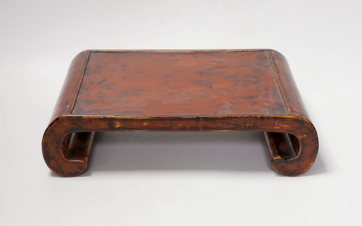 A 19th century Japanese black and red lacquer stand. 32cm wide